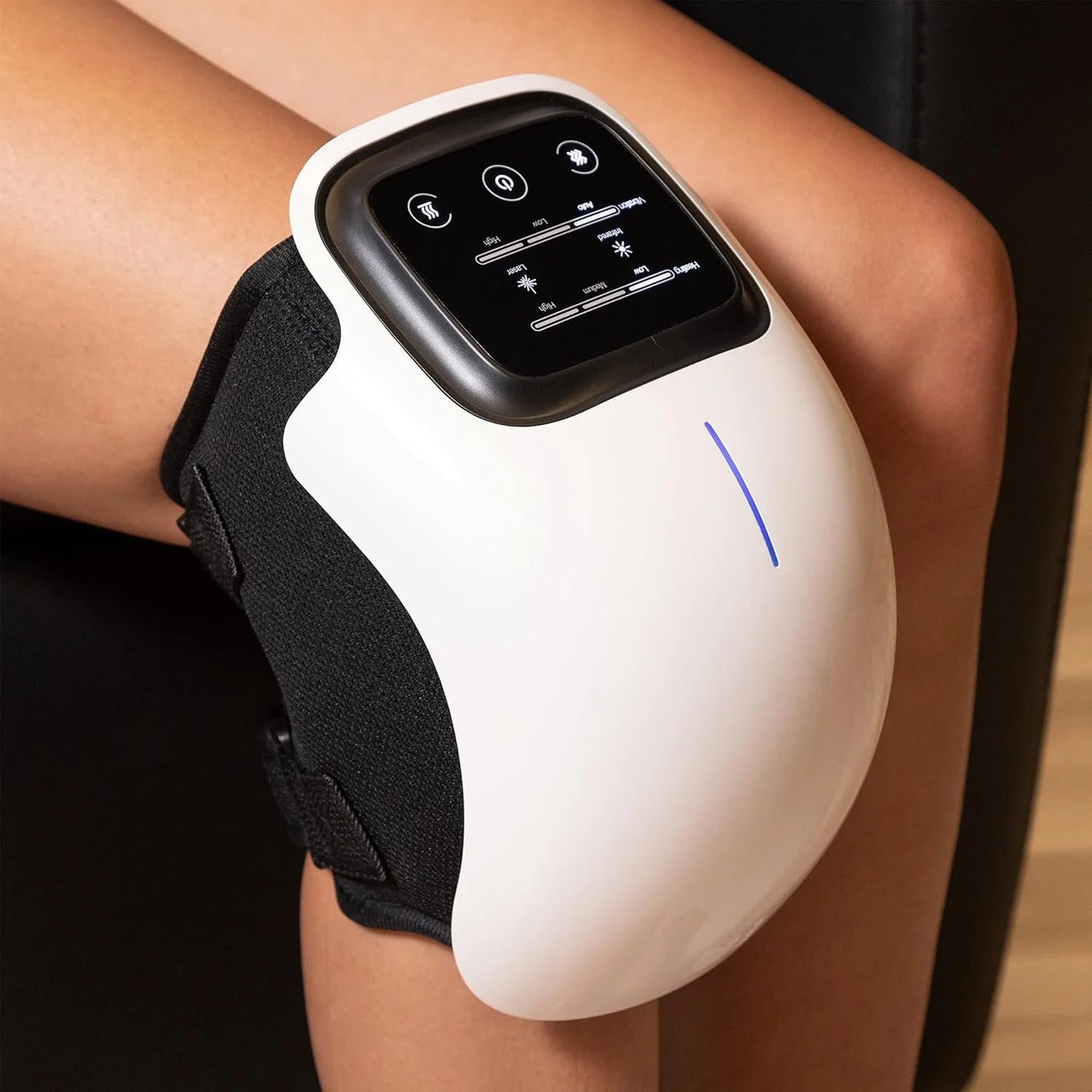 White electronic device with a screen on a person's arm, likely a smartwatch or fitness tracker.